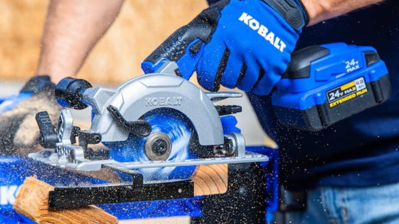 Close up of someone using a Kobalt Compact Circular Saw
