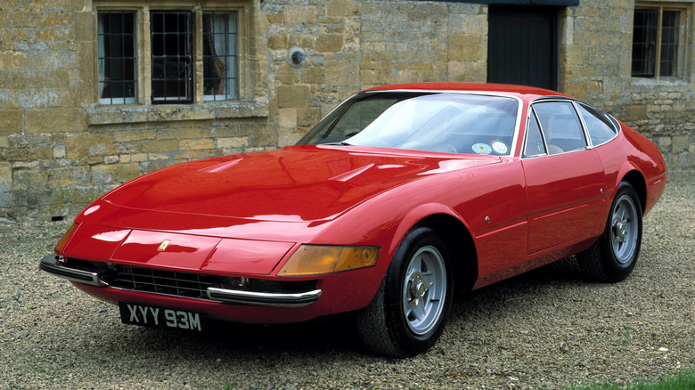 Front 3/4 view of Ferrari Daytona Coupe in front of stone house