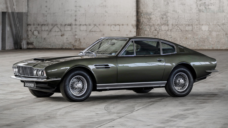 Front 3/4 view of Aston Martin DBS V8 in industrial setting