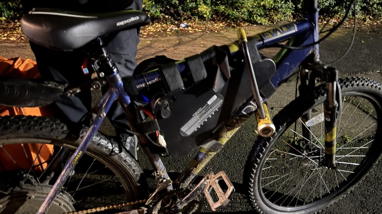 Confiscated modified e-bike photographed from side with police officer in view