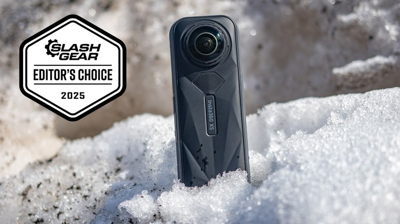 Insta360 X5 sitting in a snow bank.