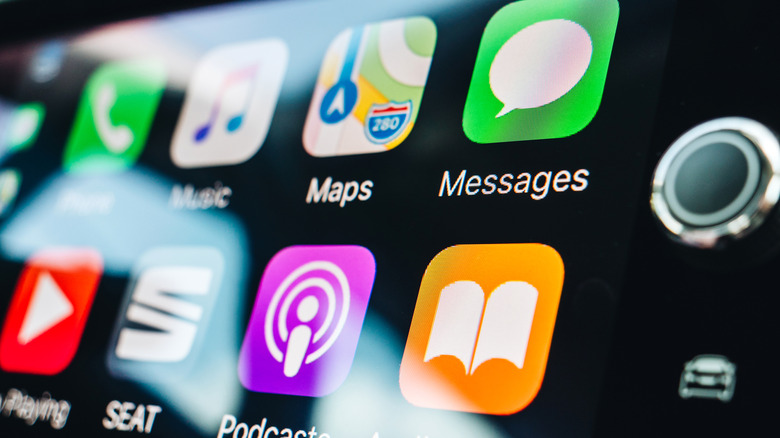 Apple CarPlay interface, featuring Maps, Messages, Music, and more, as seen on a car's infotainment system.