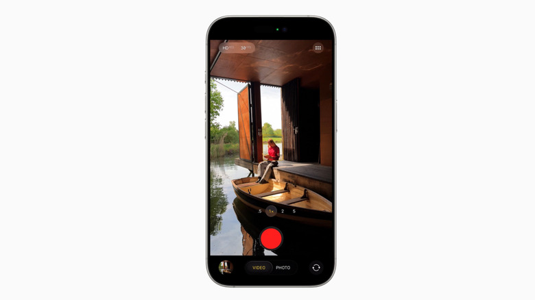 The iOS 26 Camera app showing a person next to a boat.