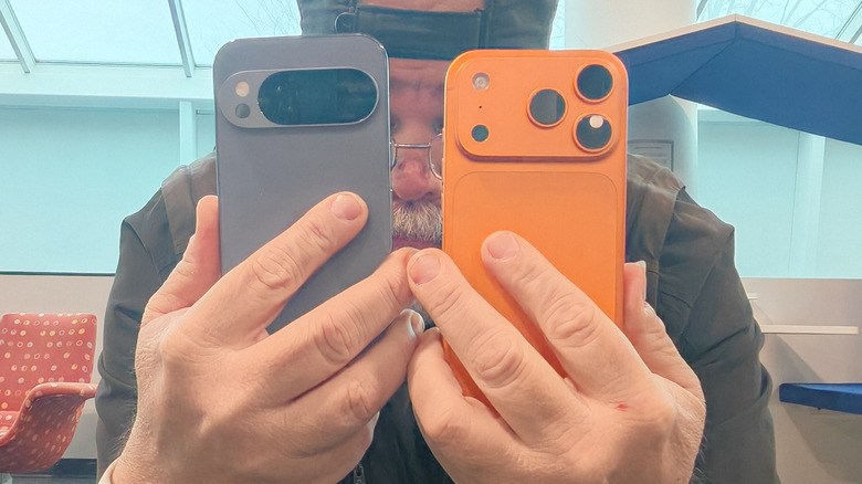 A man holding a Pixel 10 Pro and iPhone 17 Pro