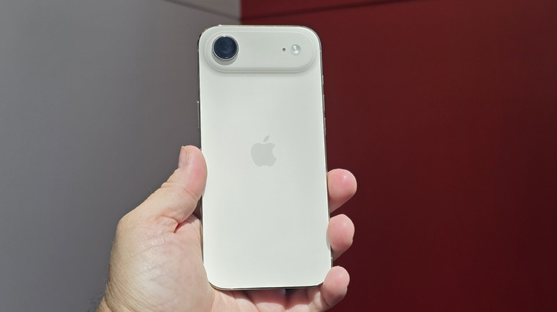 Person holding iPhone Air.