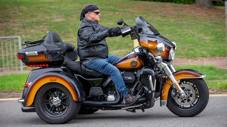 A rider on a Harley-Davidson trike motorcycle.