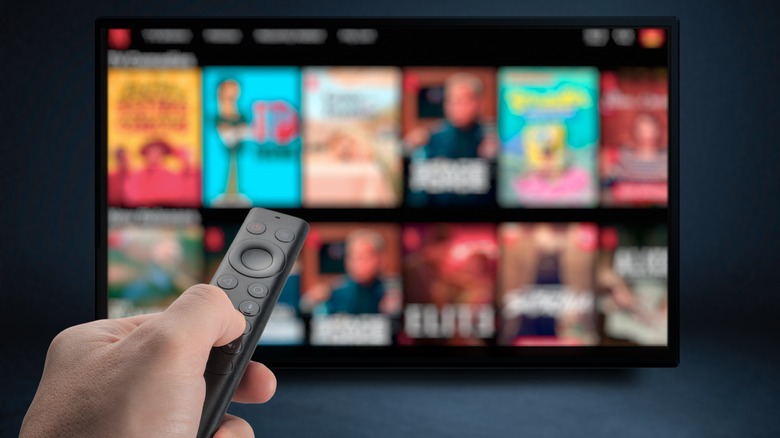 Hand pointing remote at TV