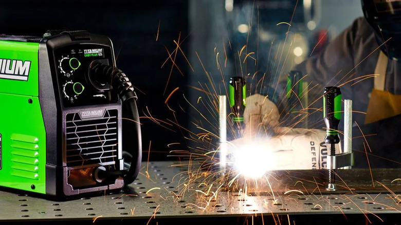 A mechanic using the Titanium 125 welder