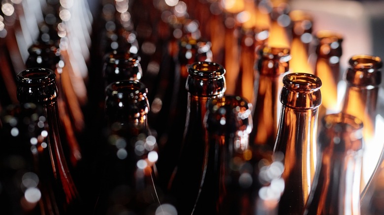 Many open beer bottles packed together
