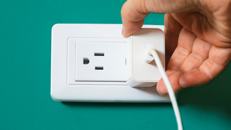 Plugging USB charger into wall