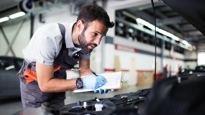 Man inspecting vehicle
