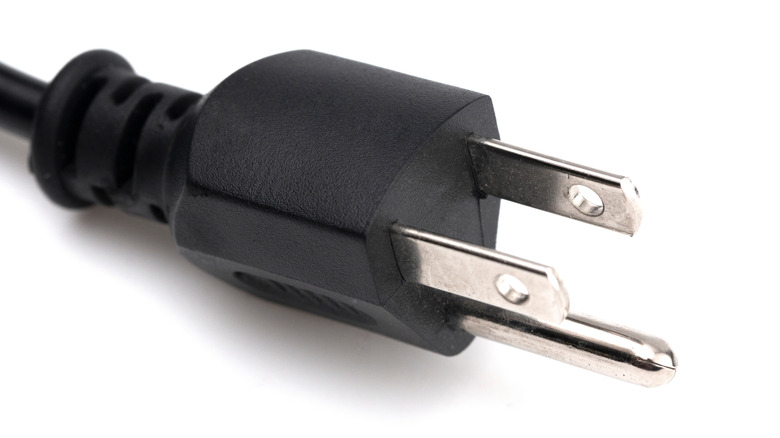 Close up photo depicting a three prong electrical plug