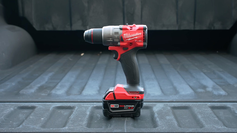 A Milwaukee Fuel M18 cordless drill on display in a vehicle's cargo area