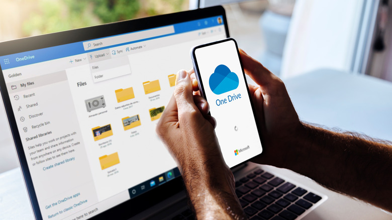 Close up of OneDrive open on phone and laptop