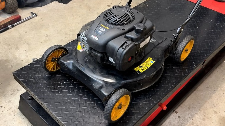 A Poulan Pro lawnmower on a lift