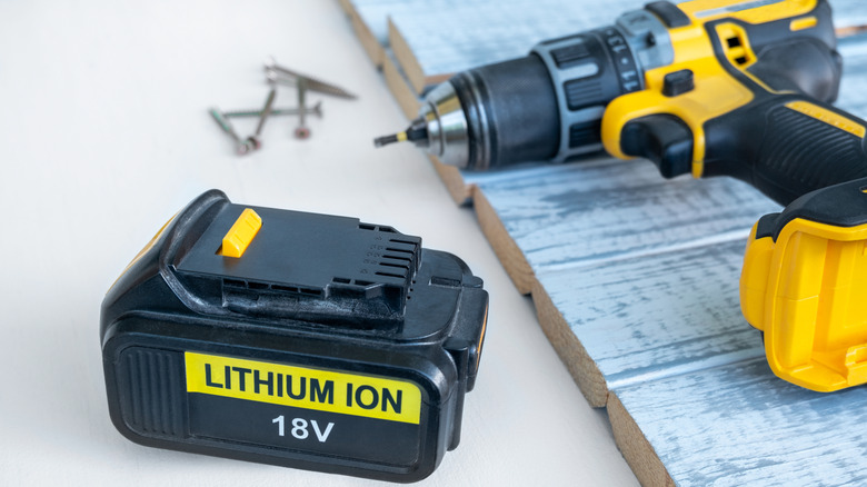 A power tool and 18-volt lithium ion battery is displayed on a work station.