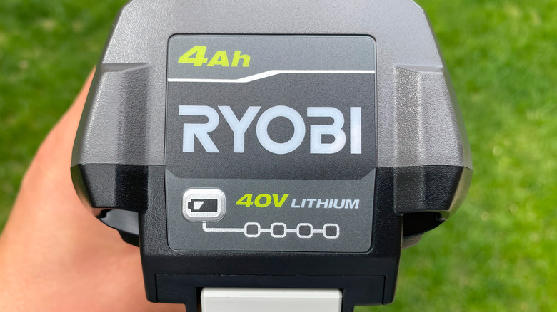 Person holding Ryobi 40V Lithium Ion Battery