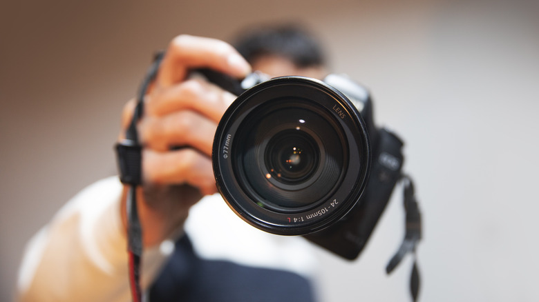 Photographer holding camera
