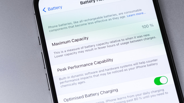 A smartphone's battery settings showing maximum capacity levels and optimized battery charging