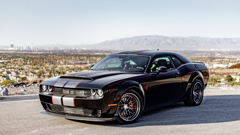 A black Dodge Demon with aftermarket tweaks parked on the mountain edge