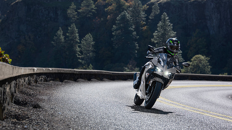Person riding a Kawasaki Ninja 500 on a mountain road