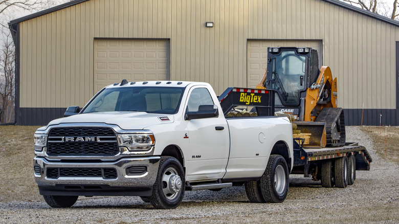 Ram 3500 Tradesman heavy duty regular cab dually parked on a gravelly surface in front of a building