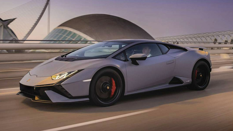 Lamborghini Huracán Tecnica driving down city street with buildings in the background