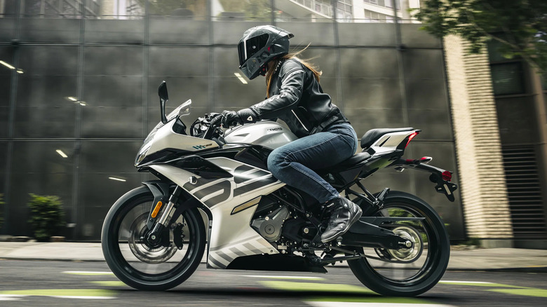 A person riding a CF Moto 300SS in the city