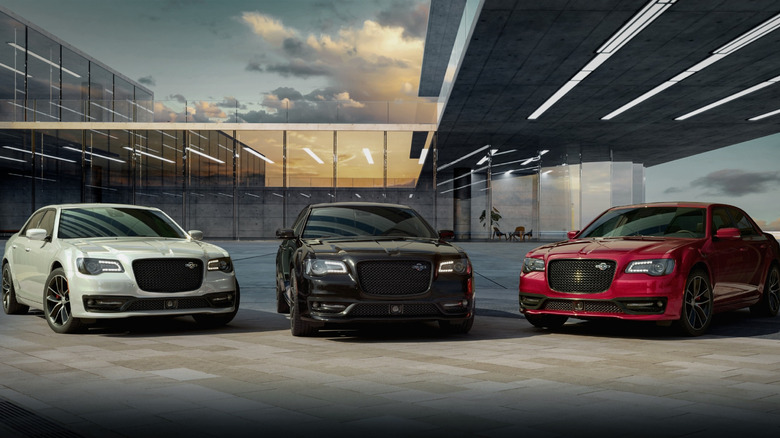 A lineup of three 2023 Chrysler 300 examples, white, black, and red