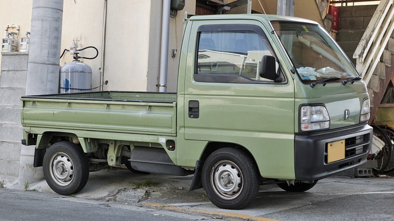 A second-generation Honda Acty mini truck in green color