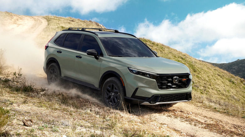 2026 Honda CR-V TrailSport on a trail in green, front 3/4 view