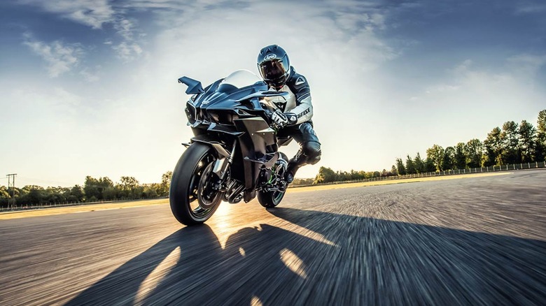 Person riding Kawasaki Ninja H2R on track