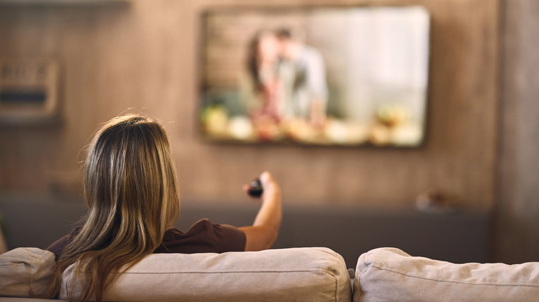 Person controlling television from a sofa