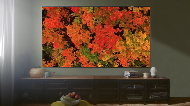 LG OLED G4 TV hanging over entertainment center