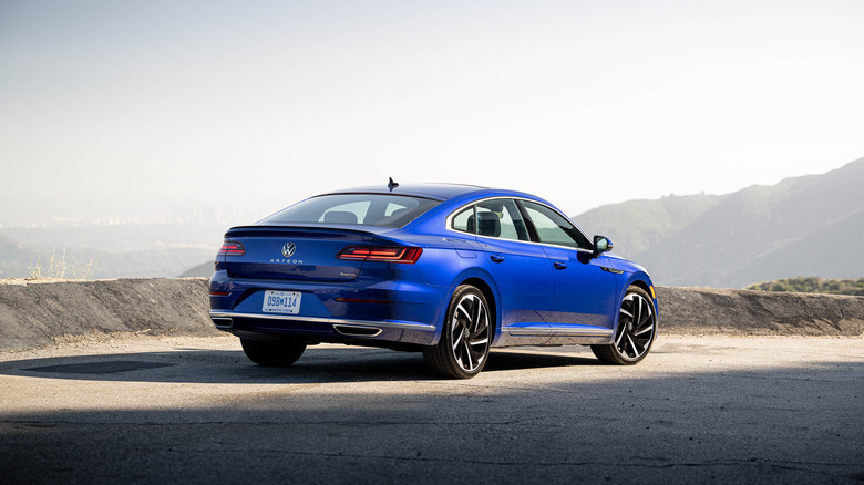 A Volkswagen Arteon R-Line parked on a lookout point, rear 3/4 view