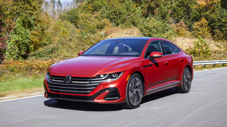 A red Volkswagen Arteon SE on the move, front 3/4 view