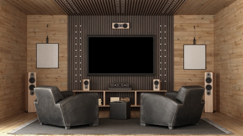 A room with two chairs and a home theater system on a wooden structue