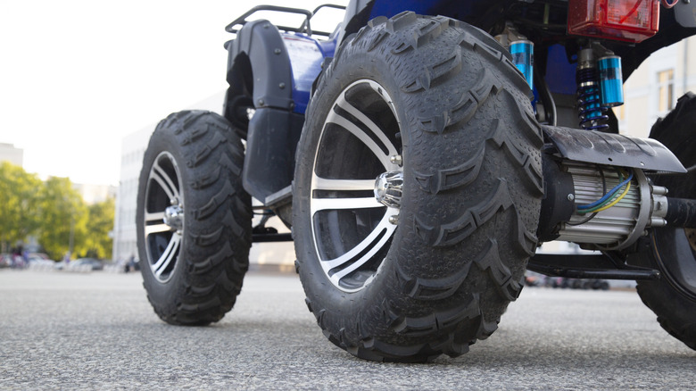 An ATV parked on a paved street.
