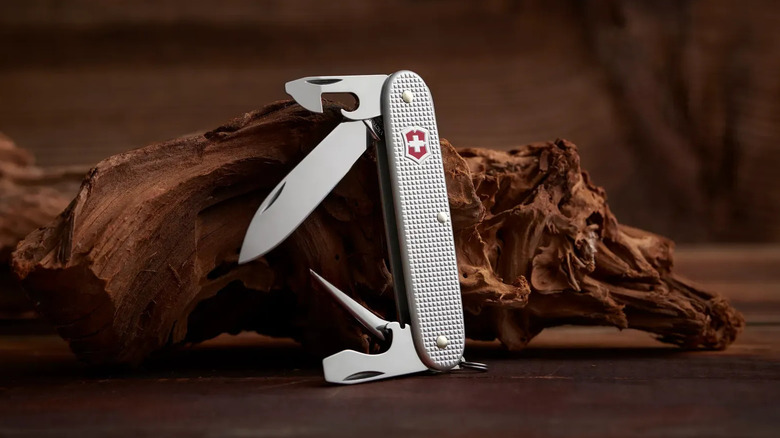 A silver color Swiss Army Knife standing upright