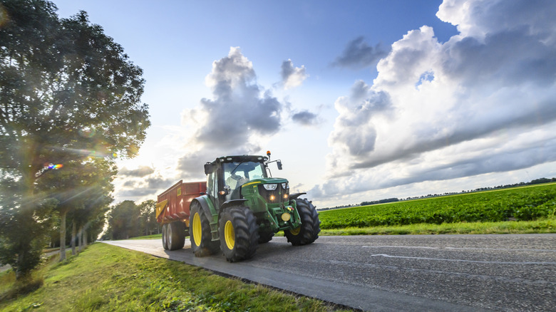 A John Deere Tractor Towing A Trailer
