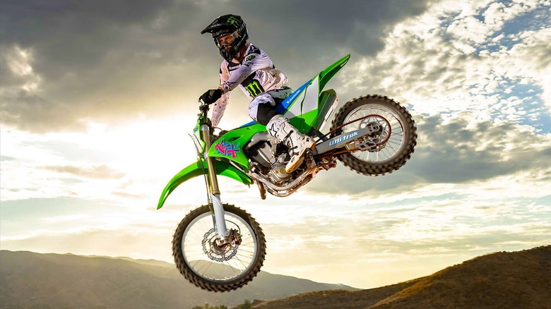Kawasaki KX Series dirt bike and rider airborne on a motocross course