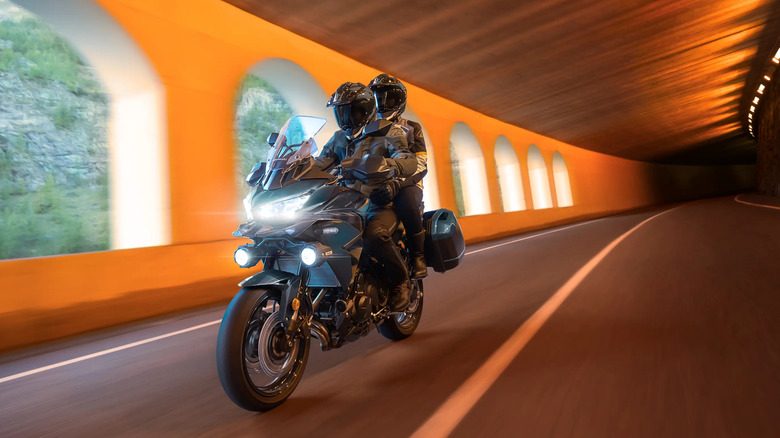 Two riders on a Kawasaki Versys 650 in a tunnel