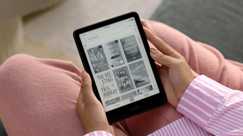 Person looking at Kindle Paperwhite settings in flower field