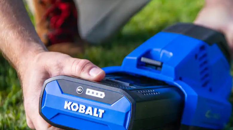 Hand inserting Kobalt 40V battery into tool