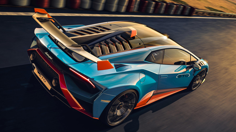 A blue and orange Lamborghini Huracán in track setting