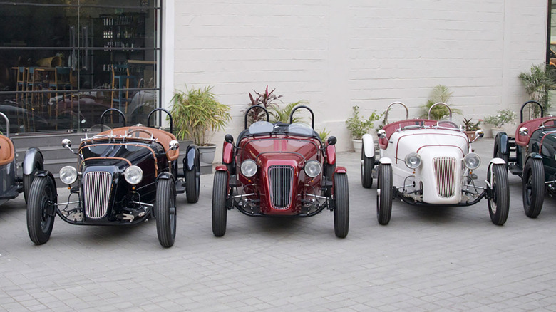A row of Austin Arrow EVs outside a showroom