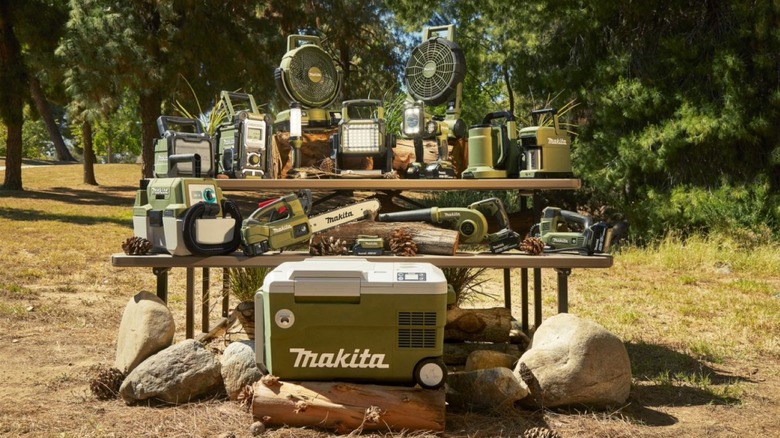 Makita's Outdoor Adventure range is layed out on a picnic table, showcasing its unique olive green color.