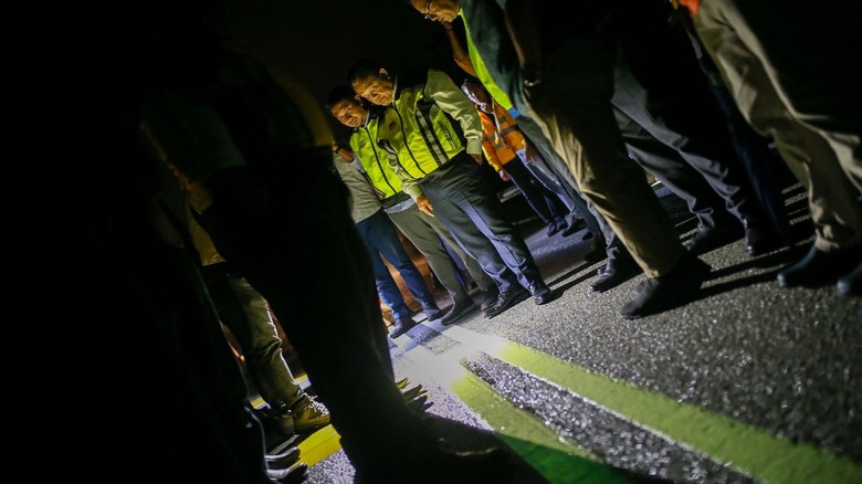 Works Minister Alexander Nanta Linggi inspects a new glowing road marking