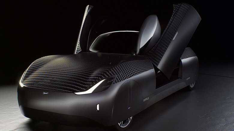 Alef Aeronautics' flying car sitting in a dark showroom with its doors open