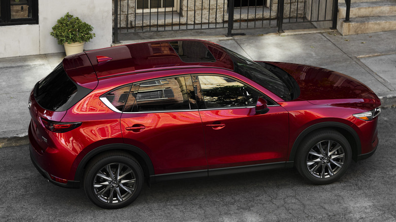 Rear 3/4 overhead view of 2021 Mazda CX-5 in city setting